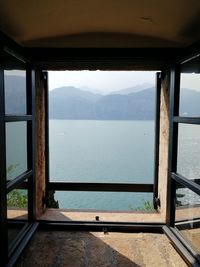 Scenic view of sea against sky seen through window