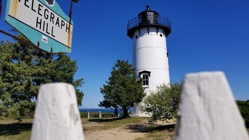 Low angle view of lighthouse against clear blue sky