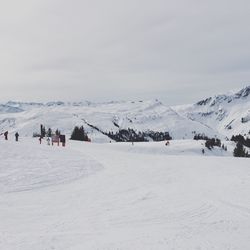 Scenic view of ski lift against sky during winter