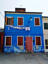 Graffiti on building against blue sky