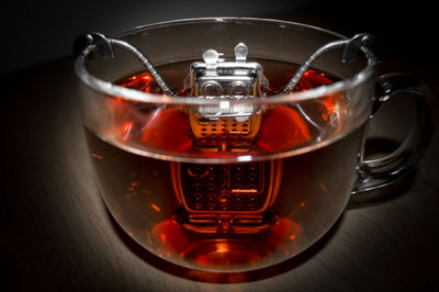 Close-up of tea cup on table against black background