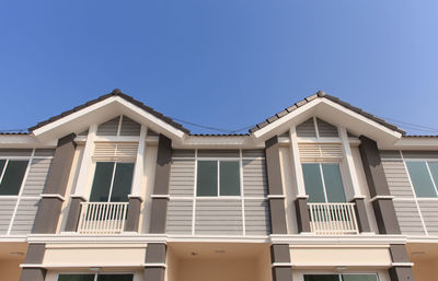 Low angle view of building against clear blue sky