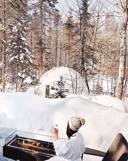 Girl drinking water next to igloo at a spa resort