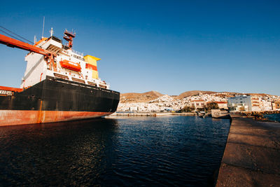 Ship moored in sea against clear sky