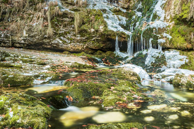 Winter. ice games in the fontanon of goriuda waterfall. friuli, italy.