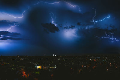 Aerial view of illuminated city at night