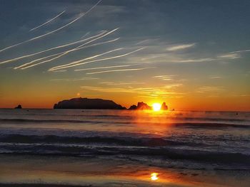 Scenic view of beach against sky during sunset