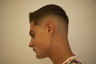 Close-up portrait of young man against white background