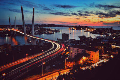 High angle view of light trails on road against sky at sunset