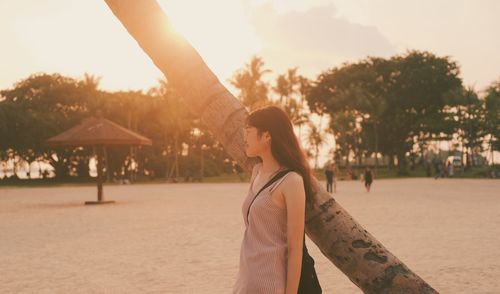 Young woman standing at beach