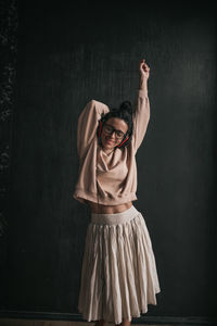 Woman standing against wall