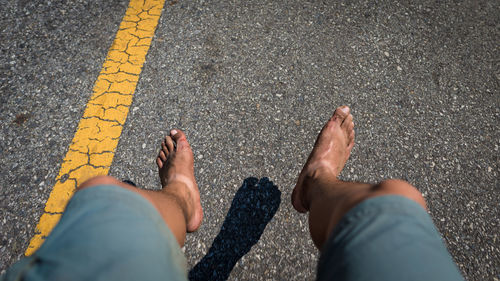 Low section of man against road