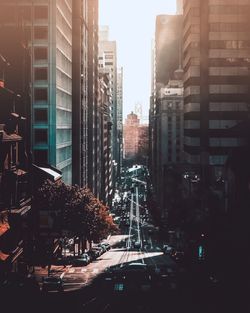 Traffic on city street by buildings against sky