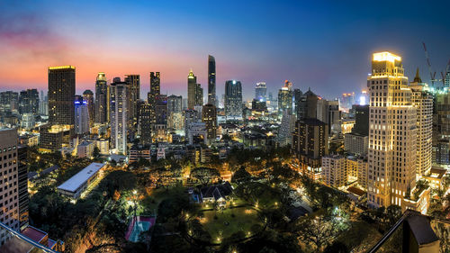 Aerial view of city lit up at night