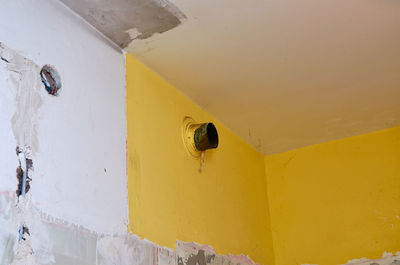 Low angle view of yellow wall