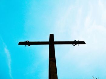 Low angle view of cross against blue sky