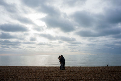 Man standing on beach against sky