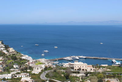 High angle view of townscape by sea against sky