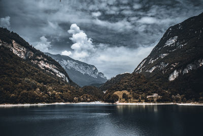 Scenic view of lake by mountains against sky