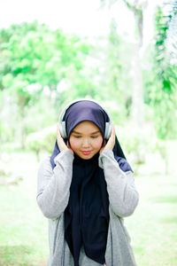 Portrait of young woman standing outdoors