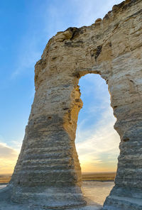 Low angle view of rock formation at sea