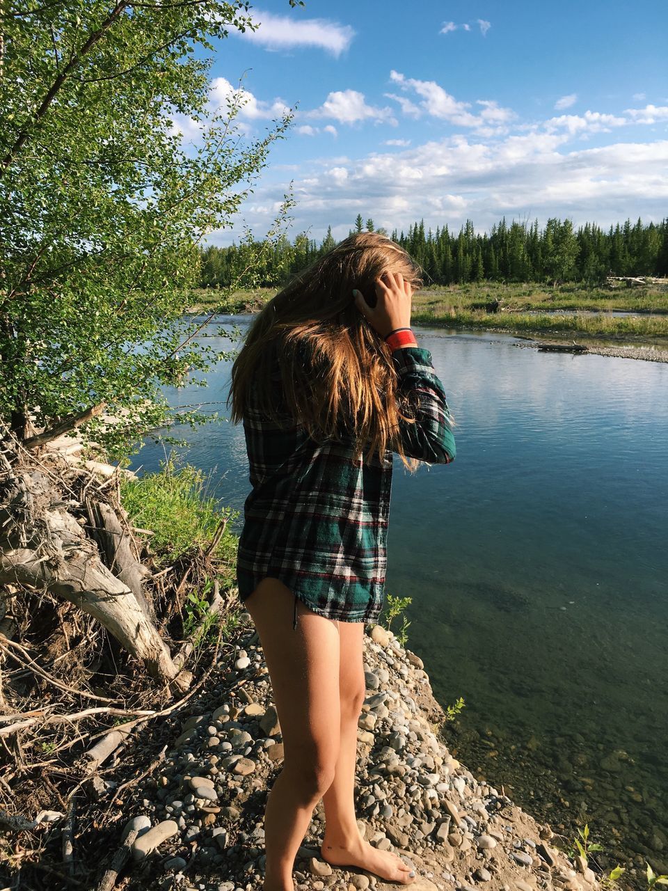 real people, leisure activity, tree, nature, one person, lifestyles, young women, standing, young adult, day, outdoors, water, casual clothing, lake, beauty in nature, full length, sky, scenics, forest, beautiful woman