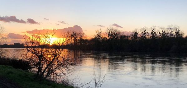 Scenic view of lake against sky during sunset