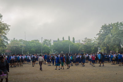 Group of students wearing school uniform in park