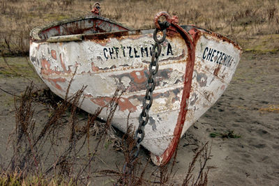 Text on old abandoned boat at beach