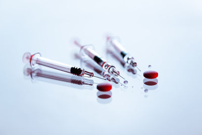 Syringes and tablets on white background, covid-19 corona virus vaccine and medicine