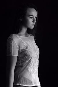 Portrait of a beautiful young woman over black background