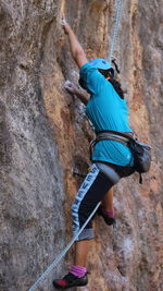 Rear view of man climbing on rock