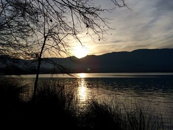 Scenic view of lake at sunset