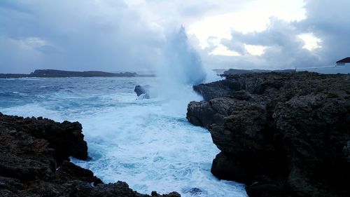 Scenic view of sea against cloudy sky