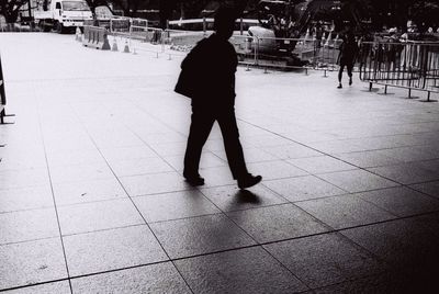 Woman walking on footpath