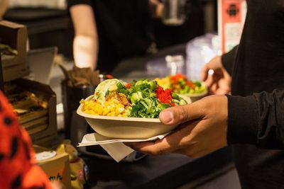 Midsection of man holding food