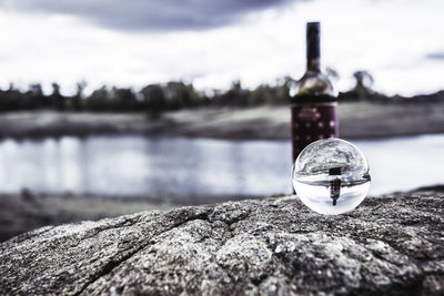 Wine bottle reflected inside glass ball