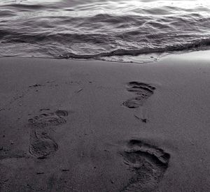 Footprints on sand at beach