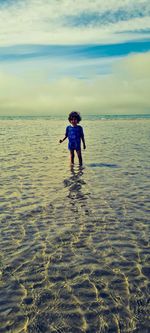 Full length of man on sea shore against sky