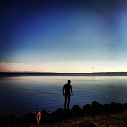 Silhouette of woman standing on beach