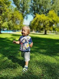 Full length of cute baby boy on grass