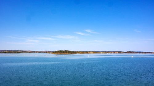 Scenic view of sea against blue sky