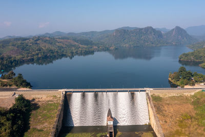 Water flowing from dam aerial landscape view