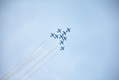 Low angle view of airplane flying against sky