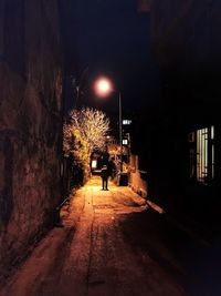 Man in illuminated city at night