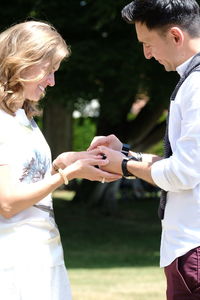 Midsection of couple standing in park