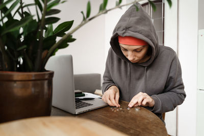 Young woman using laptop at table