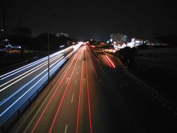 High angle view of light trails on road at night