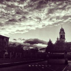 Buildings against cloudy sky