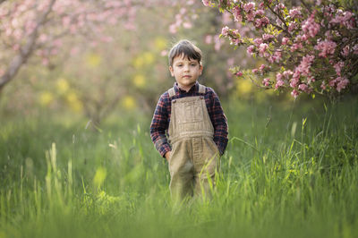 Portrait of boy standing on field